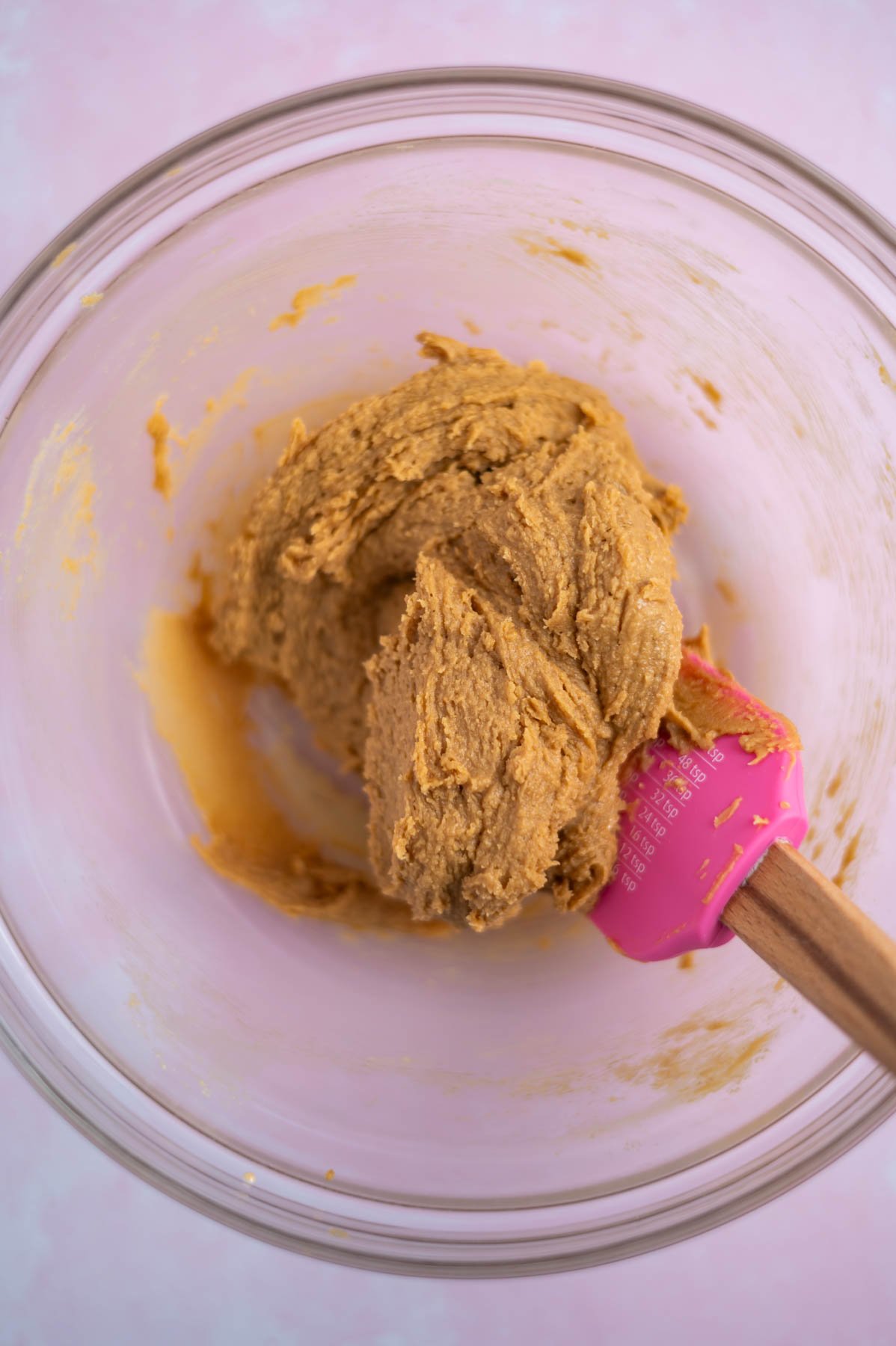 peanut butter cookie dough mixed in a bowl with a spatula