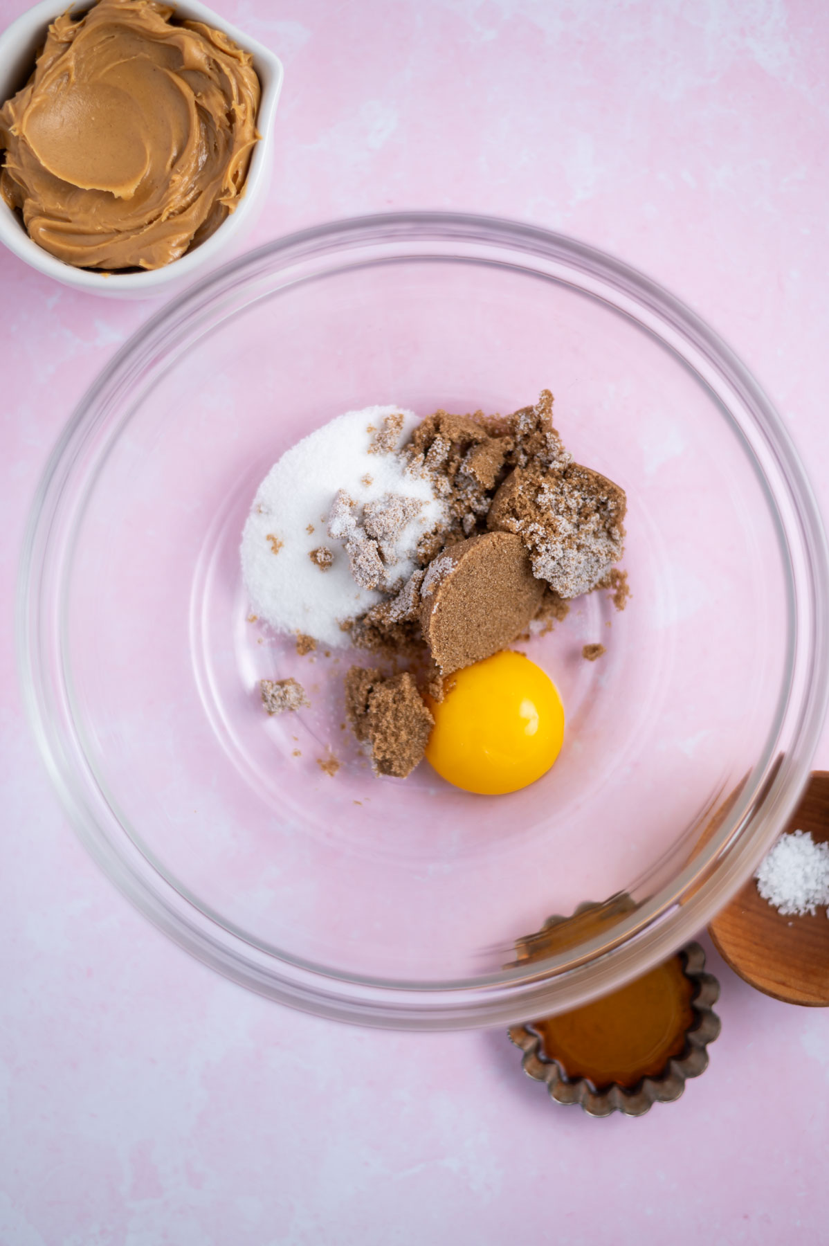egg yolk, brown and granulated sugar in a bowl