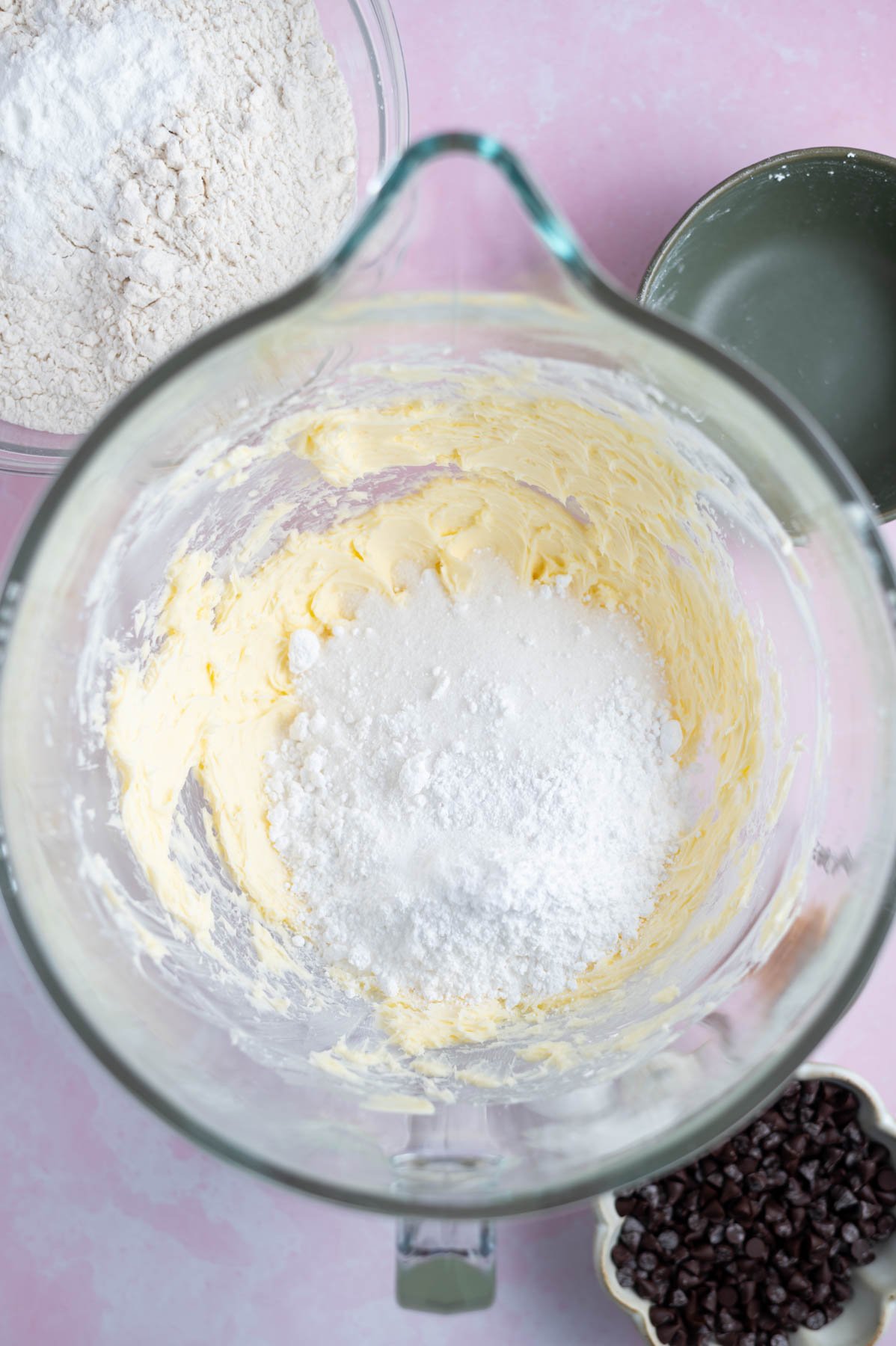 granulated and confectioners' sugar added to creamed butter in a mixing bowl