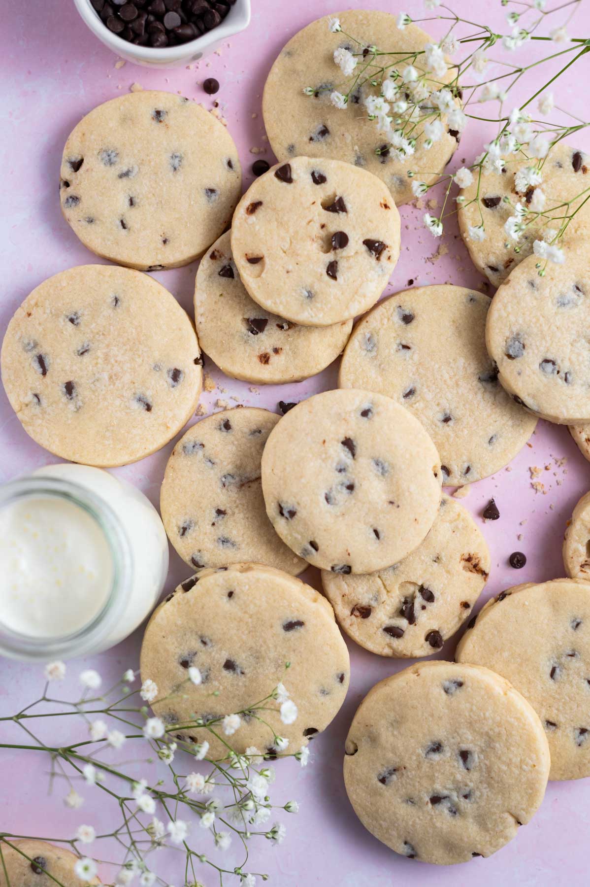 pile of cookies with milk and flowers