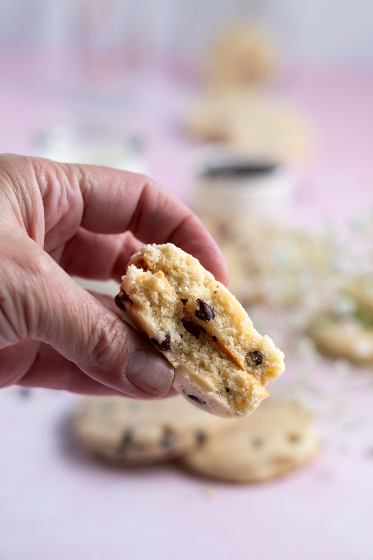 hand holding a cookie broken in half