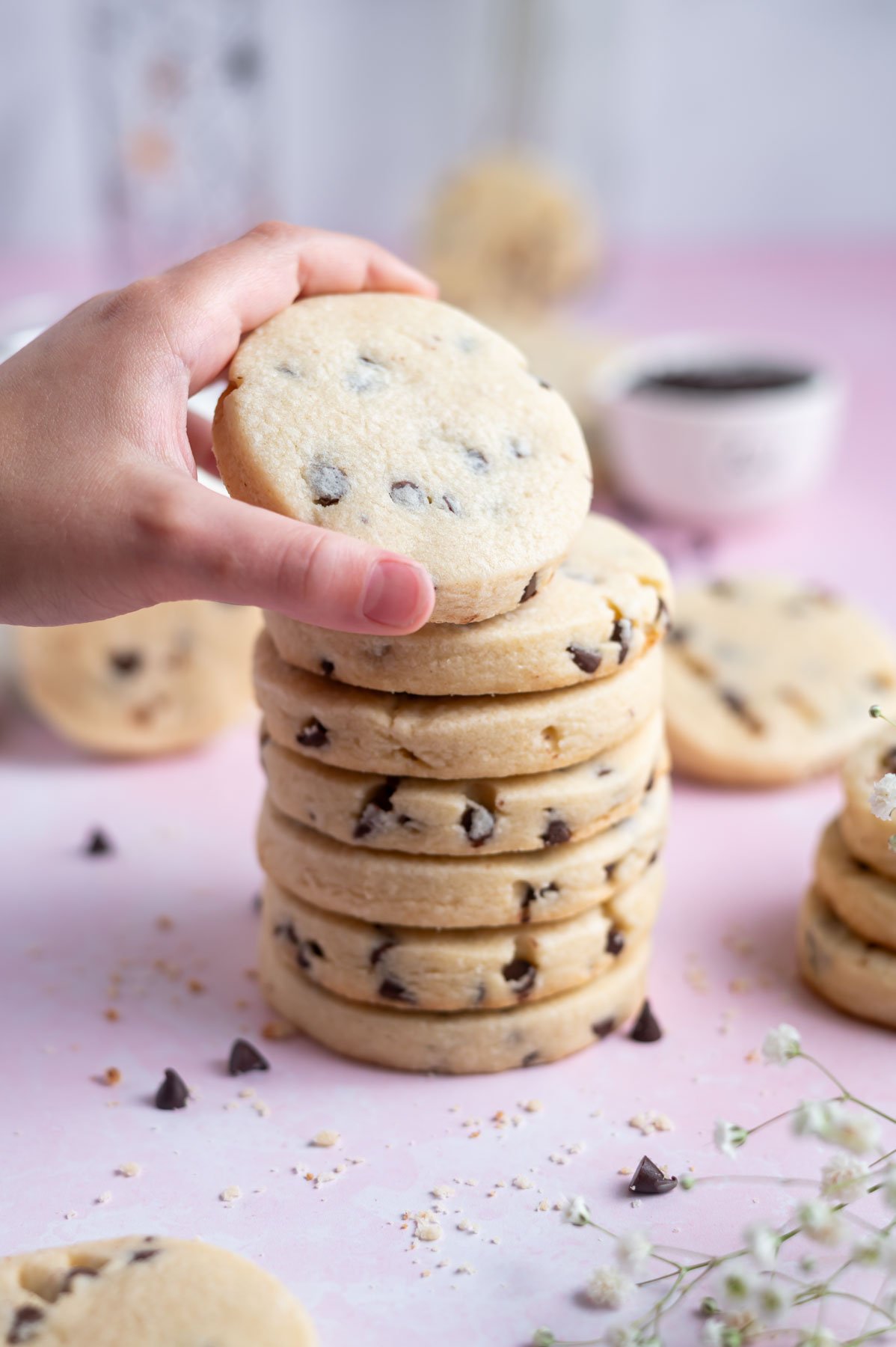 hand grabbing a cookie from a stack