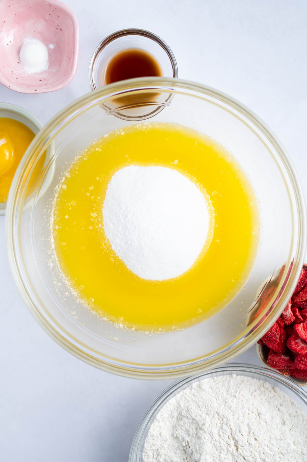 white sugar added to melted butter in a mixing bowl