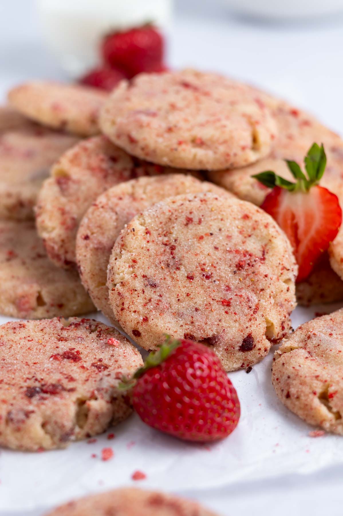 pile of strawberry sugar cookies with fresh strawberries