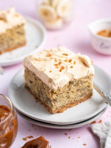 slices of cake on plate with forks and a bowl of dulce de leche