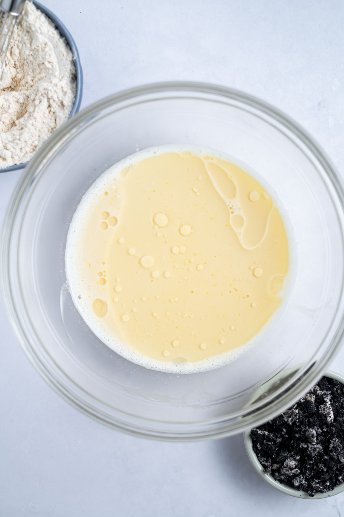 coconut oil added to wet ingredients in a mixing bowl