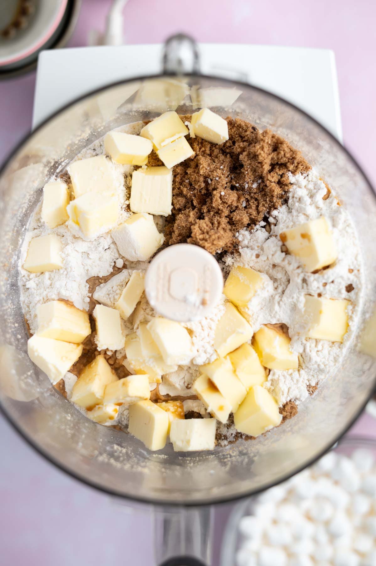 cubed butter, sugar, vanilla and flour in a bowl of a food processor