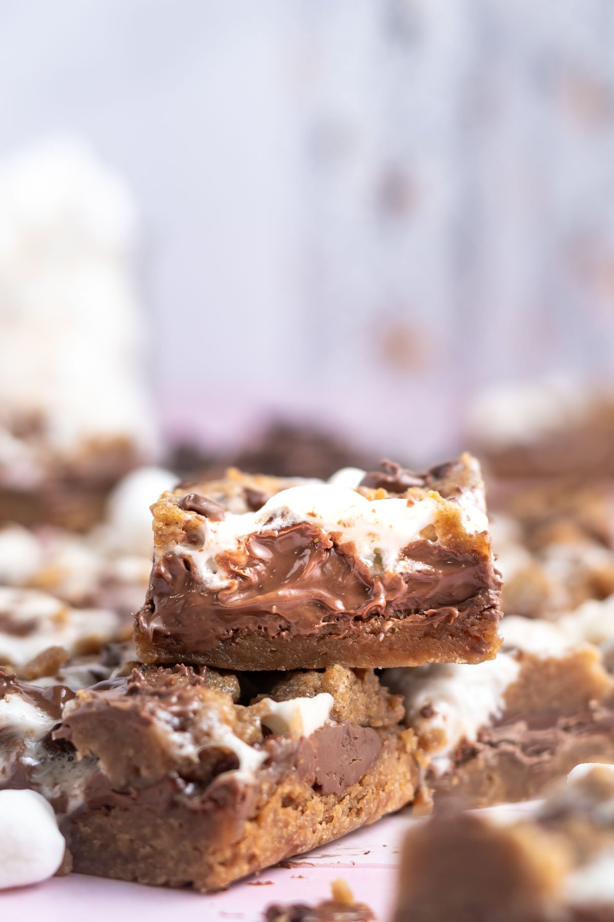 smores dessert bars stacked on one another with mini marshmallows