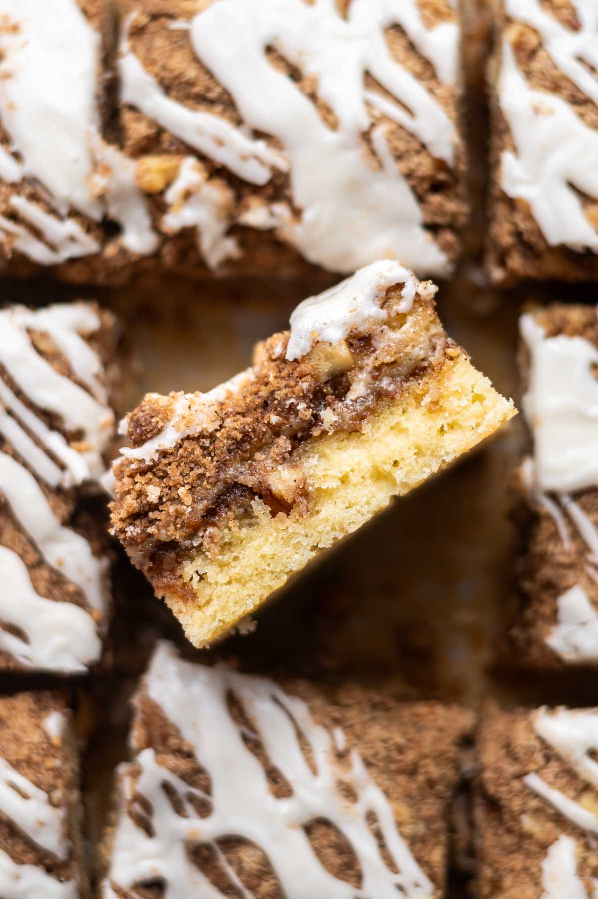 slice of coffee cake on it's side showing cinnamon walnut swirl in the middle