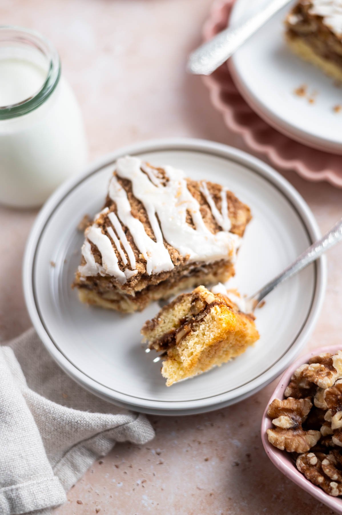 slice of cake on a plate with a fork holding a bite