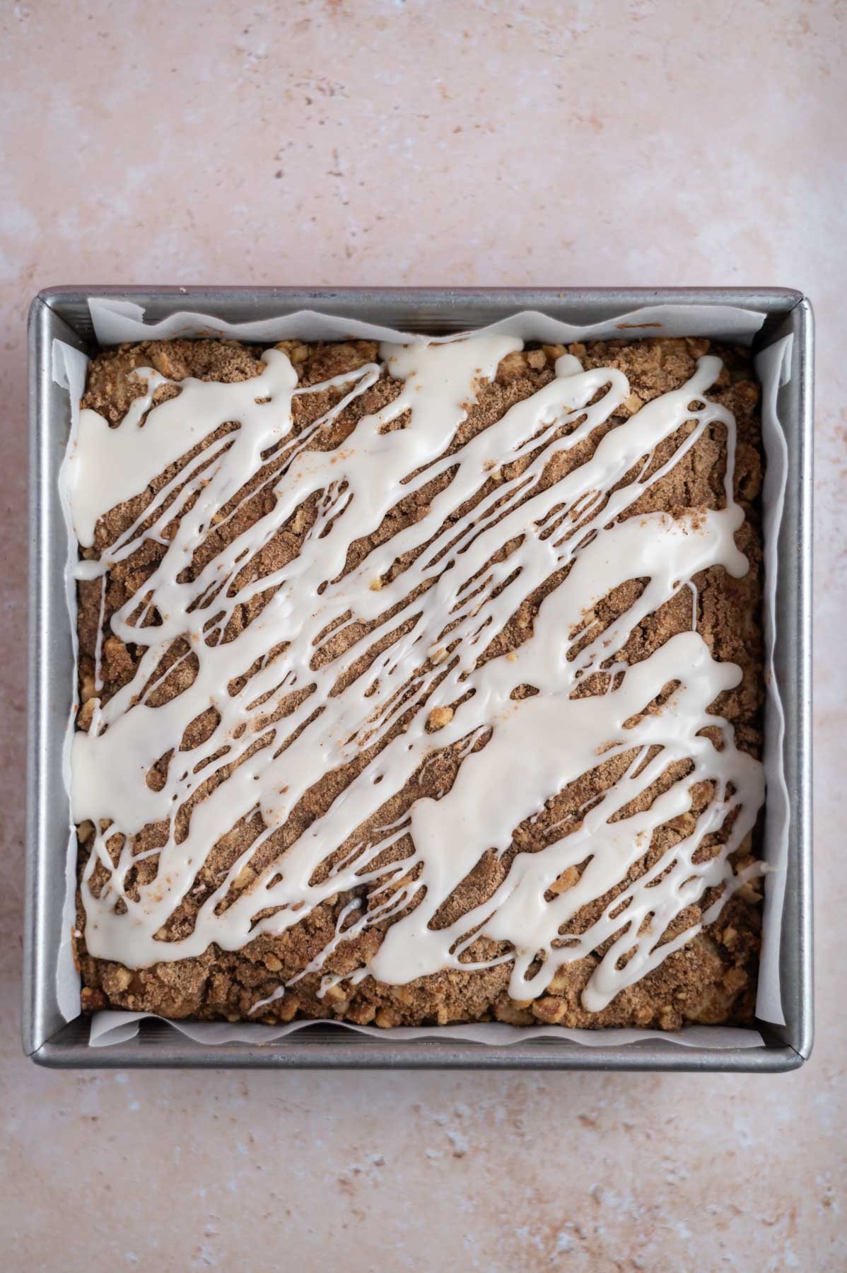 icing drizzled overtop cinnamon walnut coffee cake