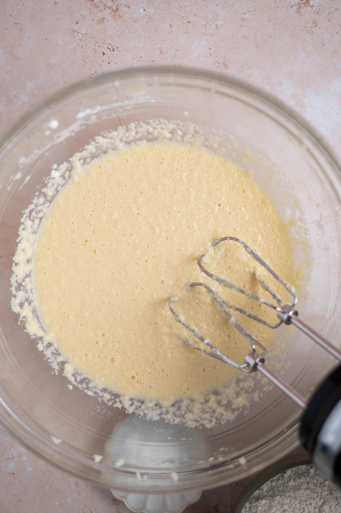 cake batter after the sour cream has been added in a mixing bowl