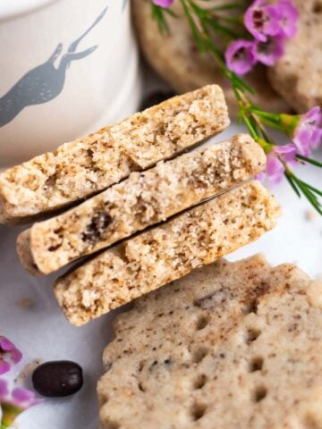 espresso shortbread cookies broken in half to show tender and slightly crumbly texture