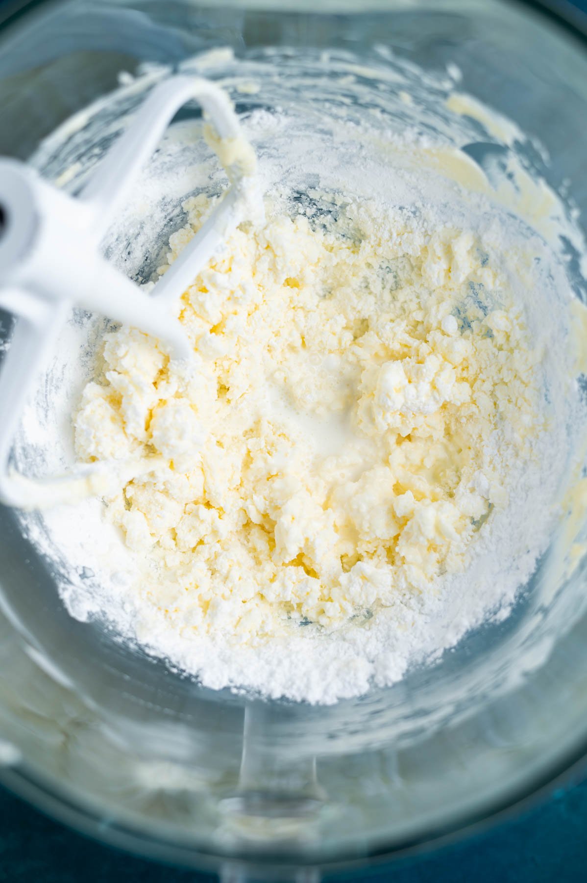 confectioners' sugar added to butter in a mixing bowl