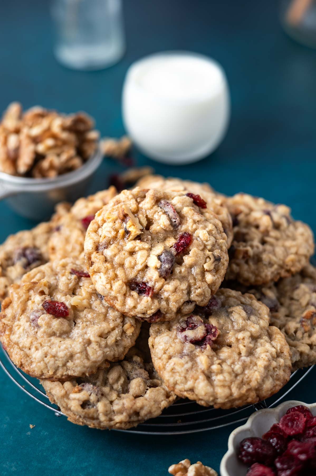 cookies on a cooling rack with a glass of milk in the background