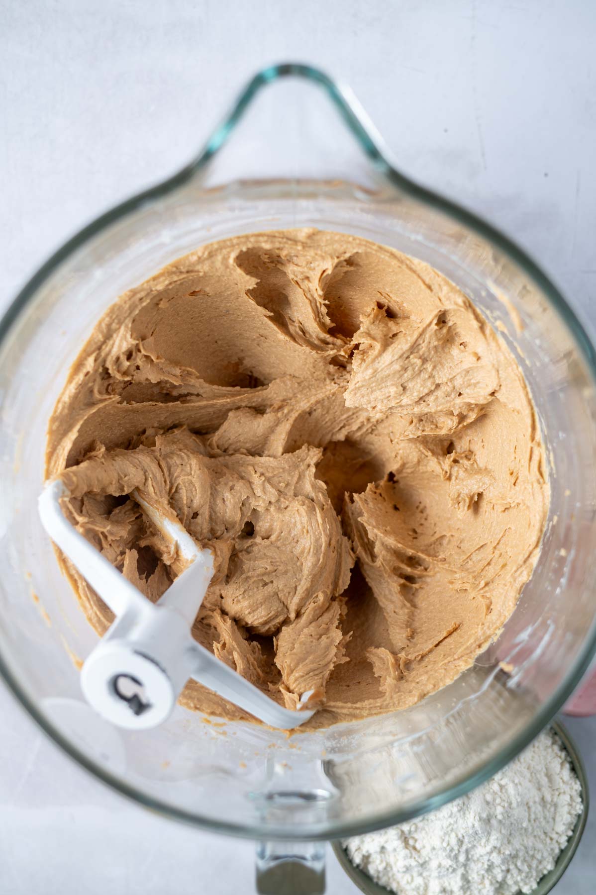 eggs and vanilla beaten into other peanut butter cookie dough in mixing bowl