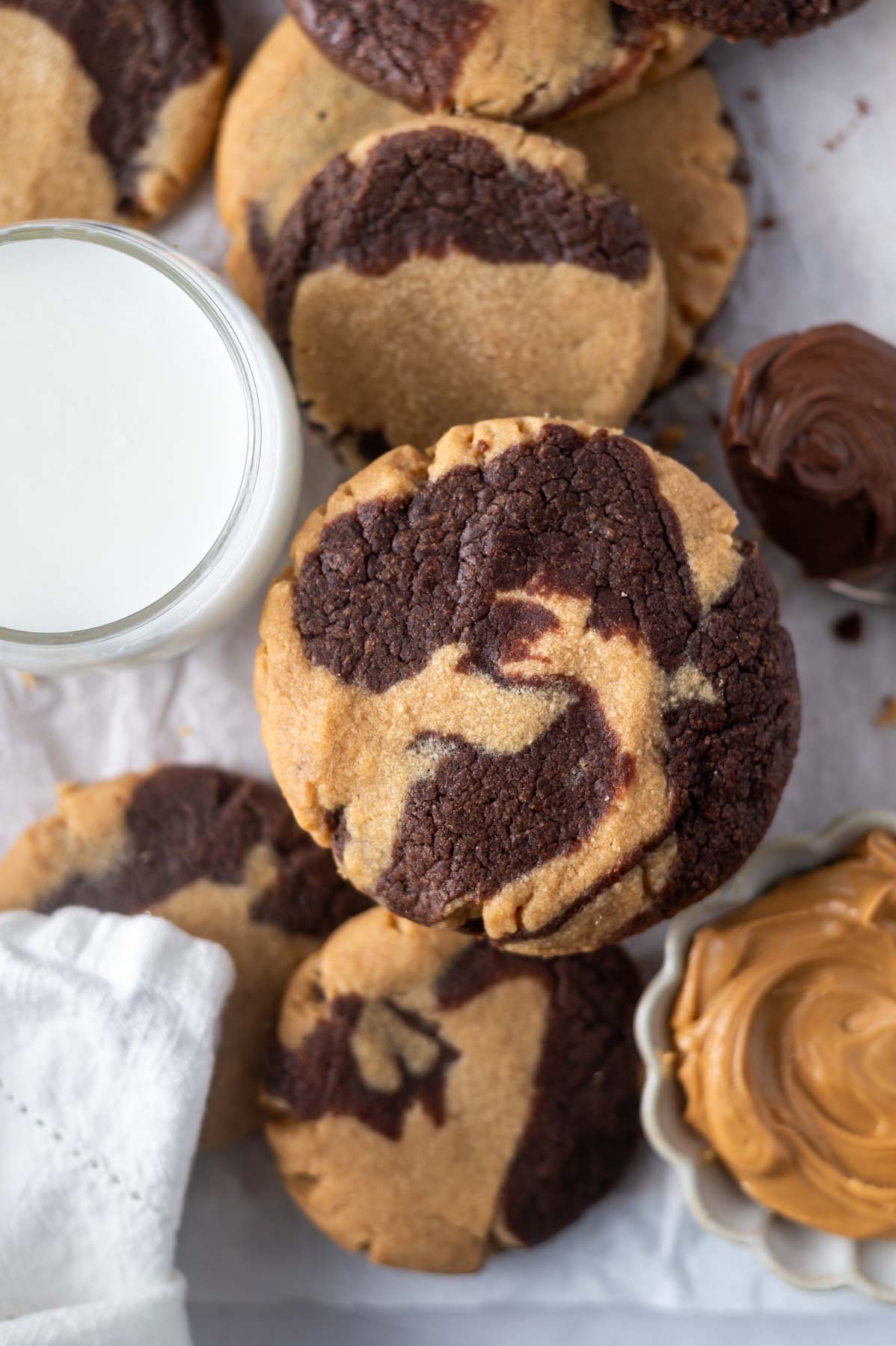 cookies with a glass of milk and bowl of peanut butter