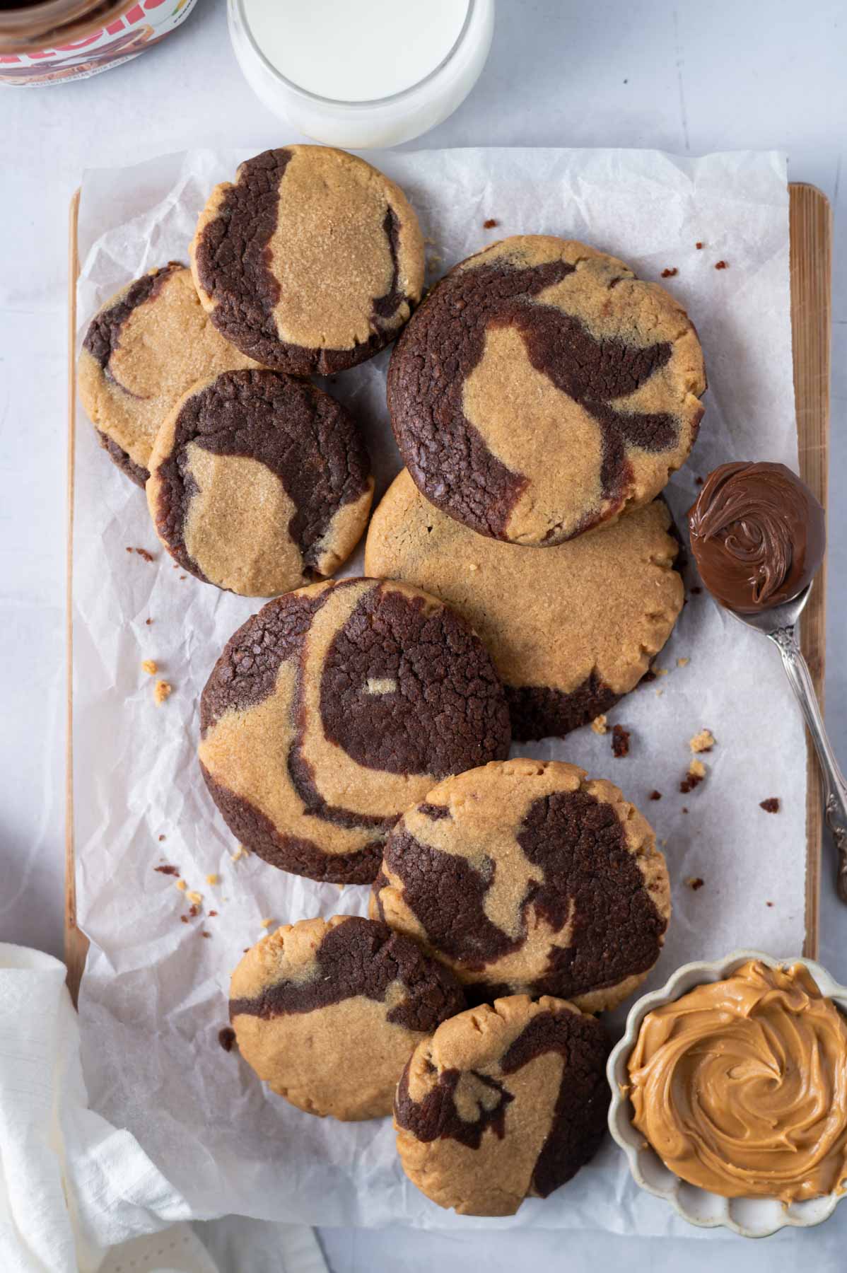 pile of cookies on a parchment lined cutting board