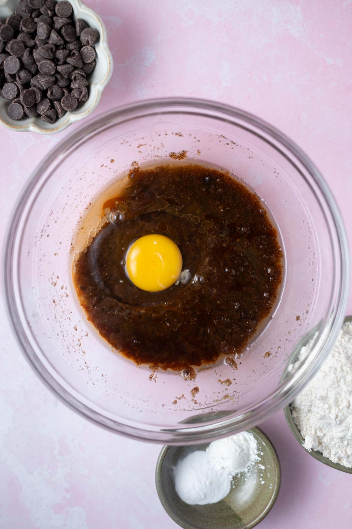 egg and vanilla added to butter and sugars in a mixing bowl