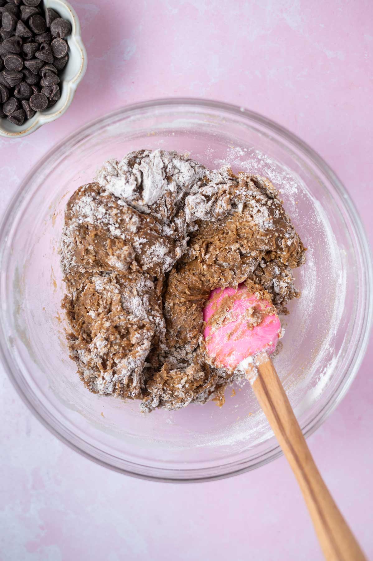 flour mixed into cookie dough with a spatula until some large streaks of flour remain