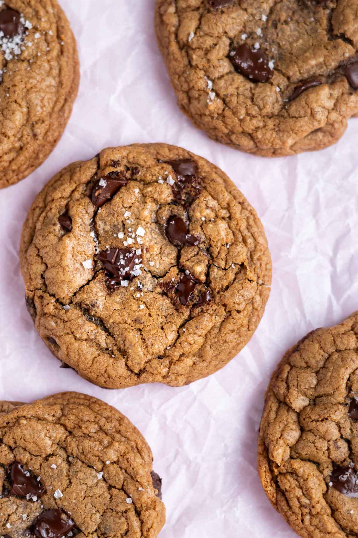 espresso chocolate chip cookies with flaky sea salt on parchment paper