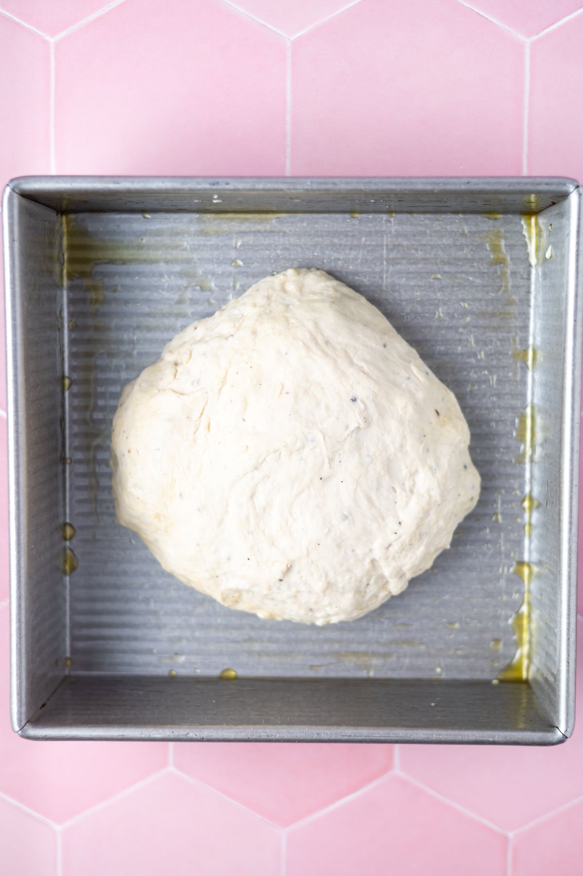 bread dough in oiled baking pan