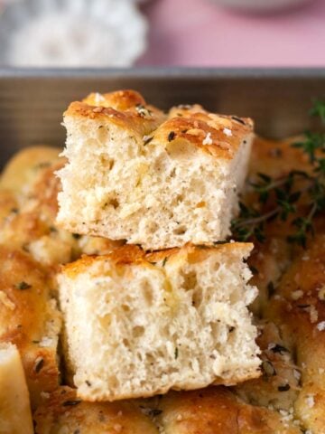 pieces of bread stacked on top of each other in a baking tin