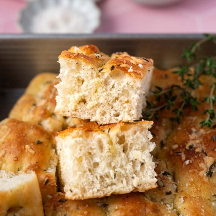 pieces of bread stacked on top of each other in a baking tin