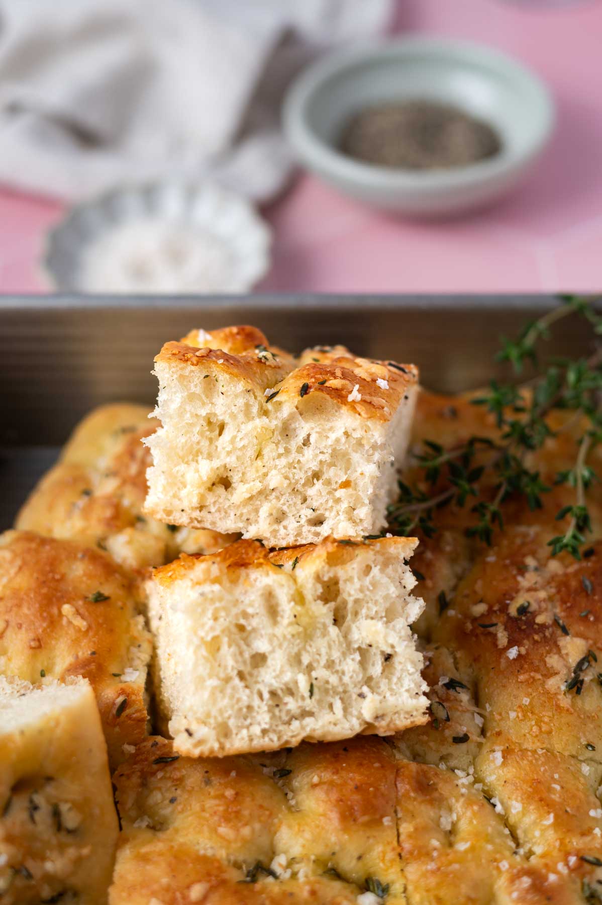 pieces of bread stacked on top of each other in a baking tin