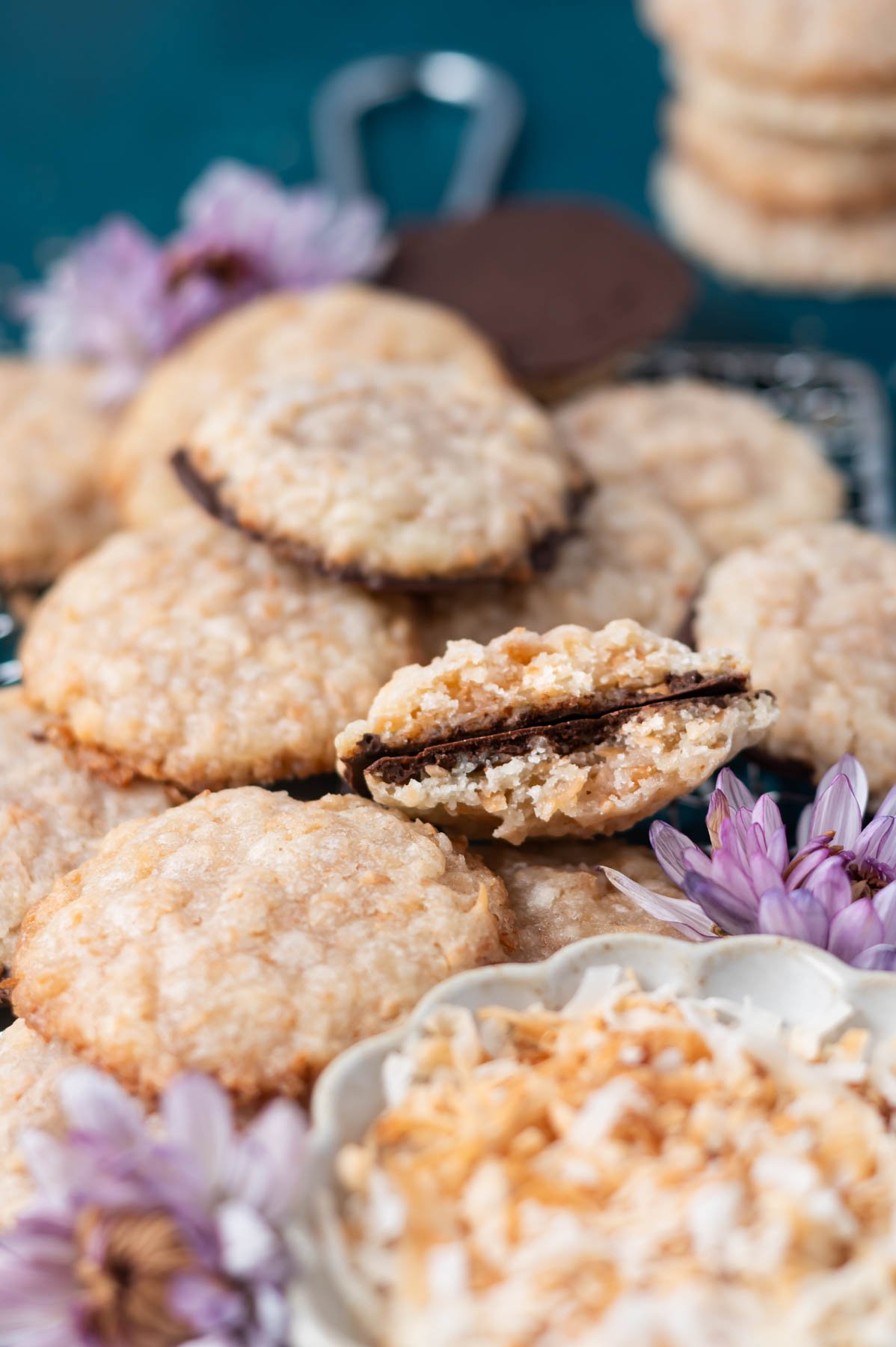 broken cookie, showing thin chocolate coated bottom in a pile of cookies