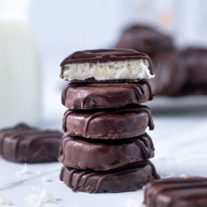 stack of chocolate candies with the top cut to show the coconut middle