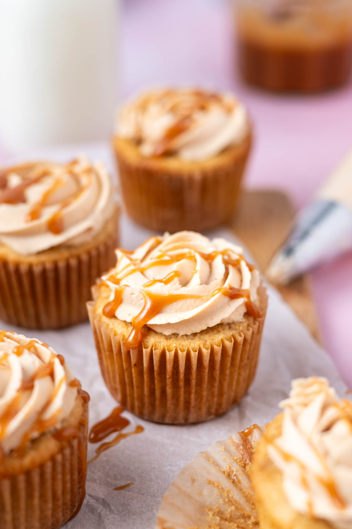 cupcakes with a drizzle of caramel sauce over the frosting