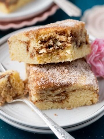 two slices of churro cake on a plate with a fork