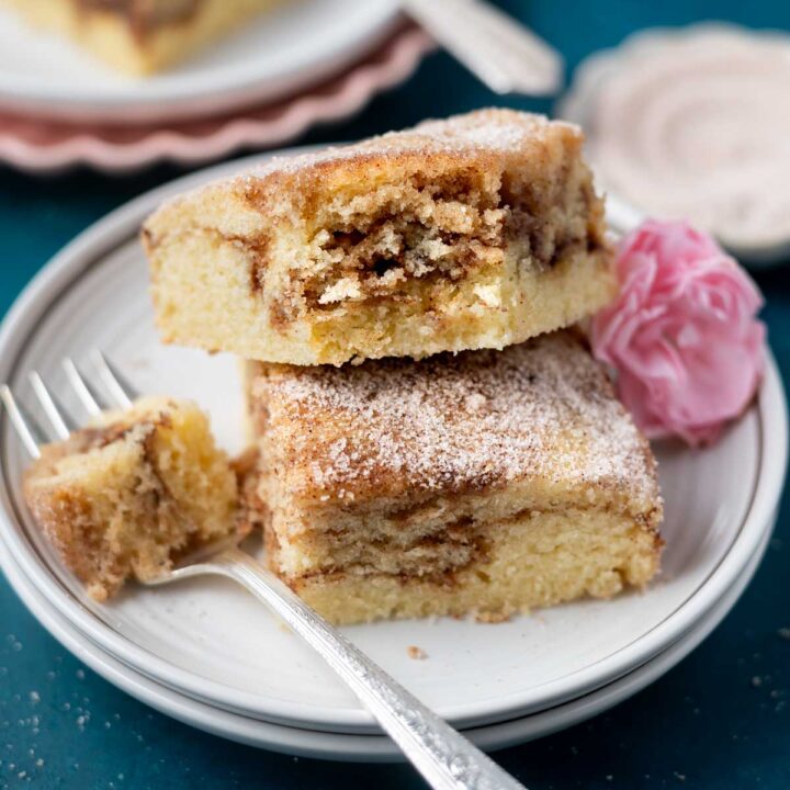 two slices of churro cake on a plate with a fork