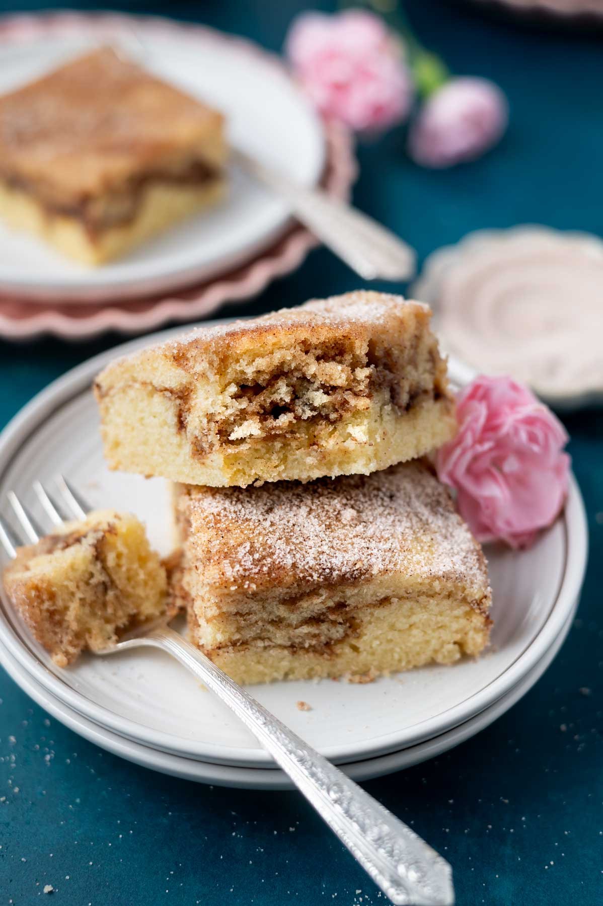 two slices of churro cake on a plate with a fork