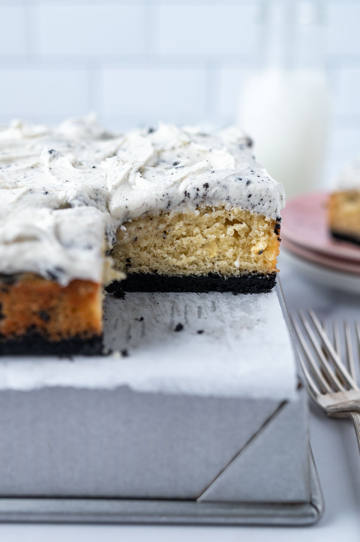 oreo cookie crusted cake on a baking pan showing the vanilla crumb