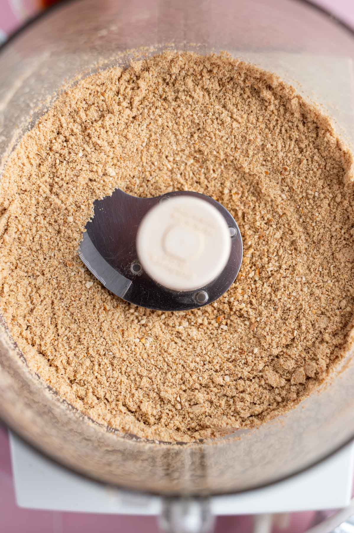 crushed graham crackers and pretzels in the bowl of a food processor