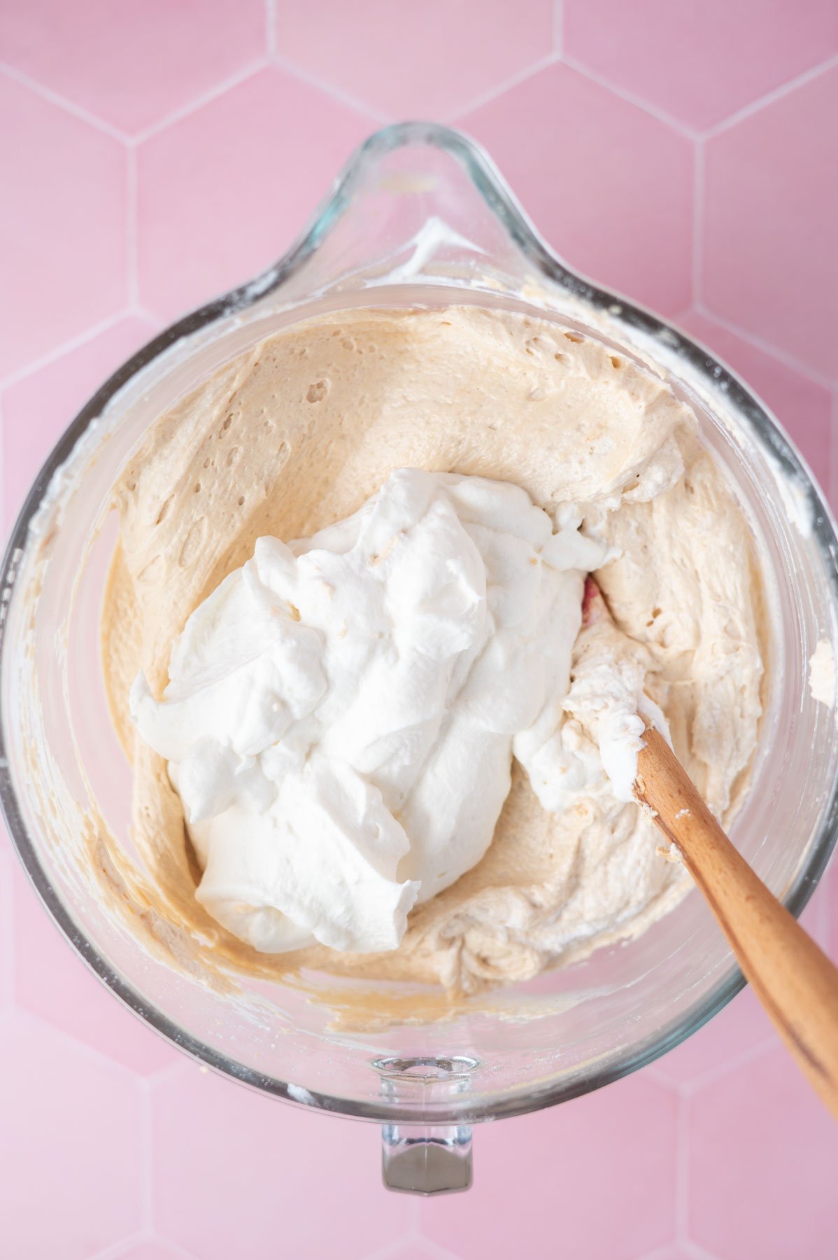 homemade whipped cream being folded into peanut butter cream cheese mixture