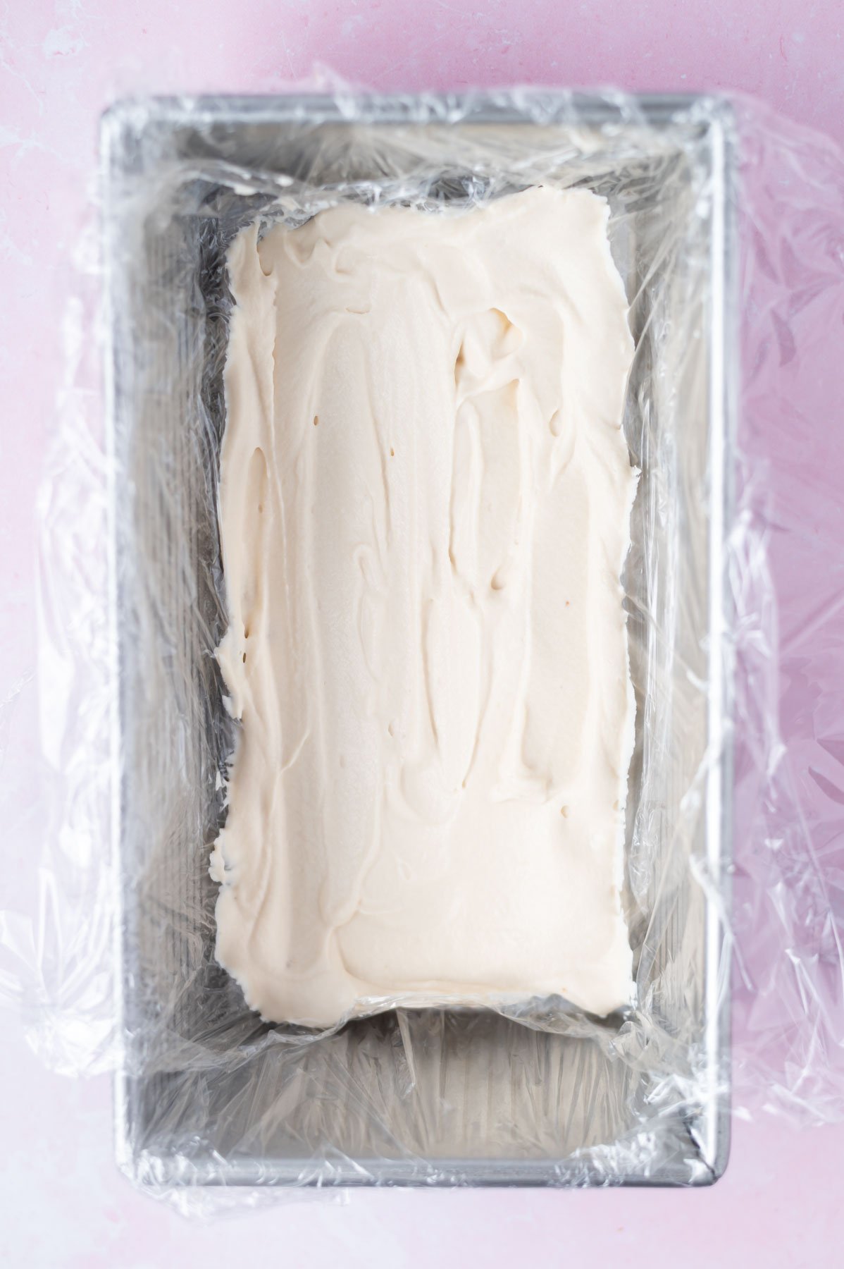 cream layer spread into a plastic lined loaf pan