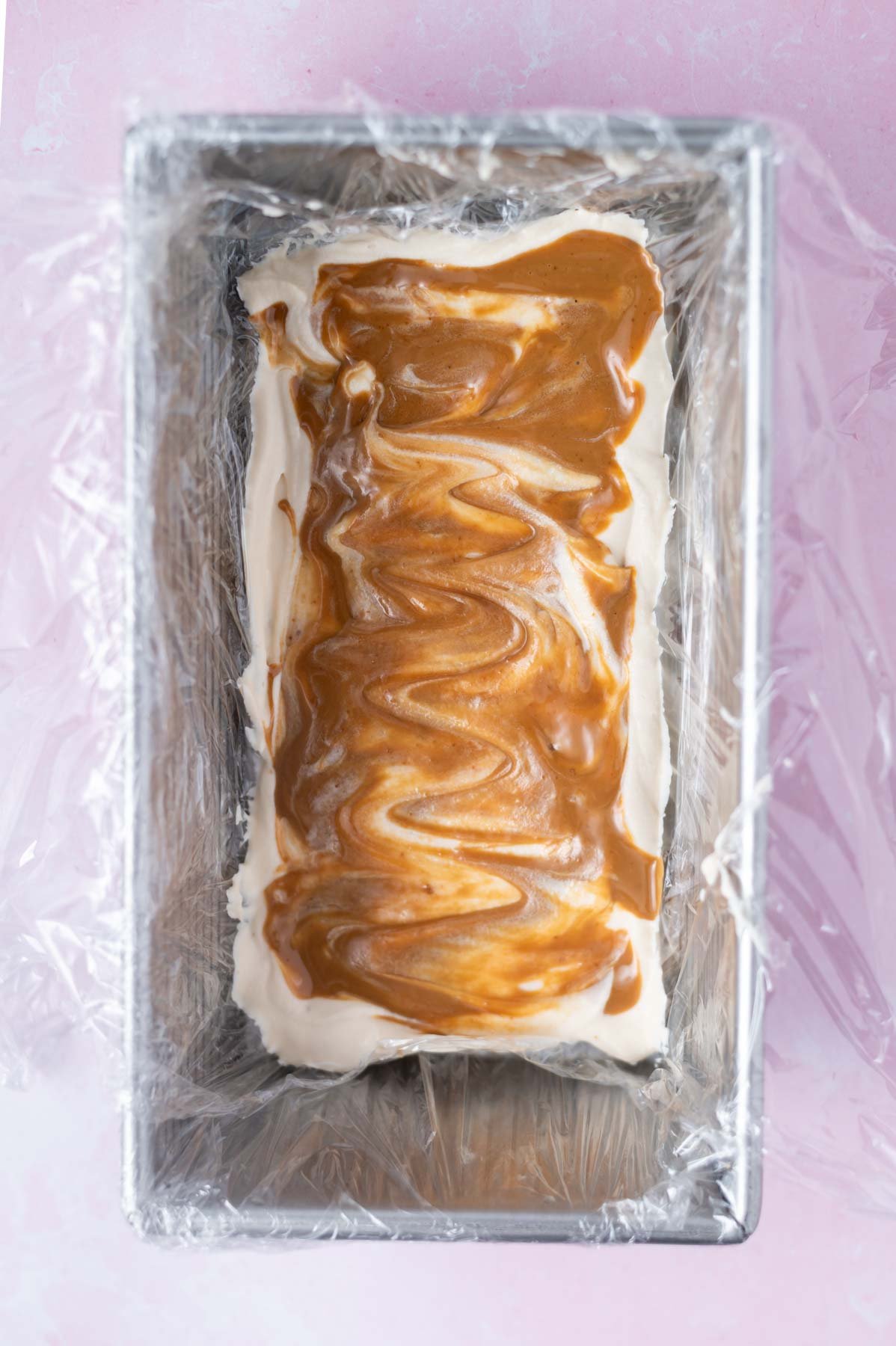 cookie butter spread over cream layer in a loaf pan