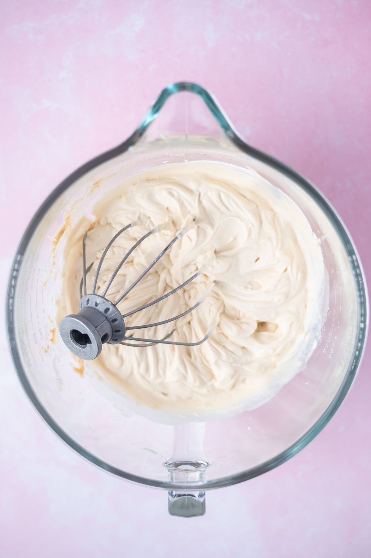 biscoff whipped cream in a mixing bowl with the whisk
