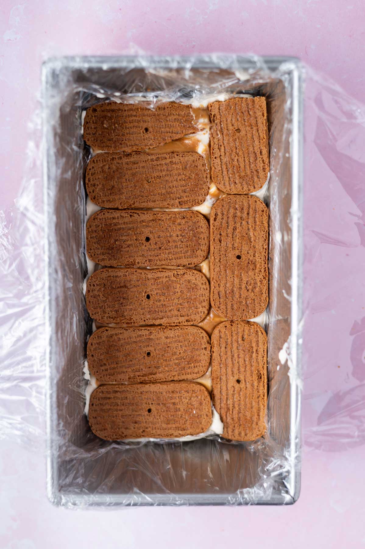 speculoos cookies layered over cream layer in a loaf pan