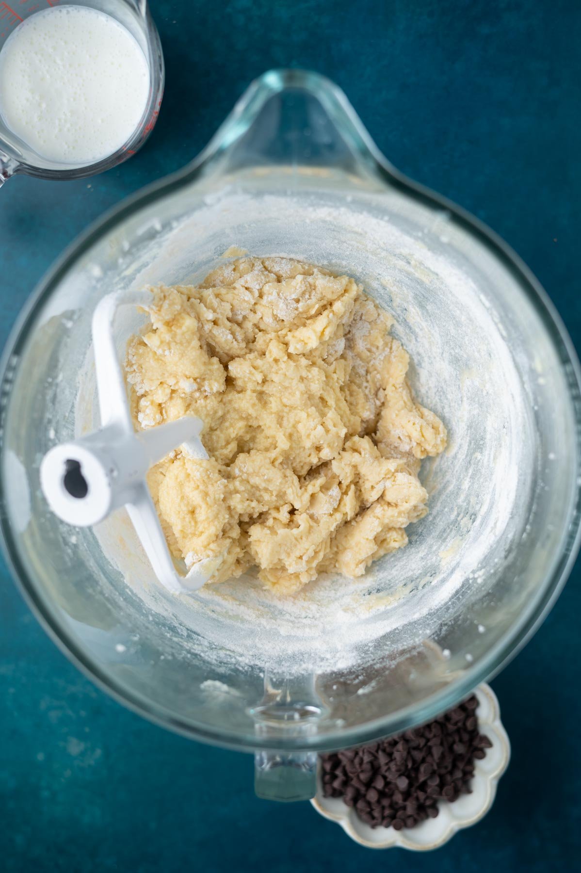 cake batter still showing some streaks of flour in a mixing bowl