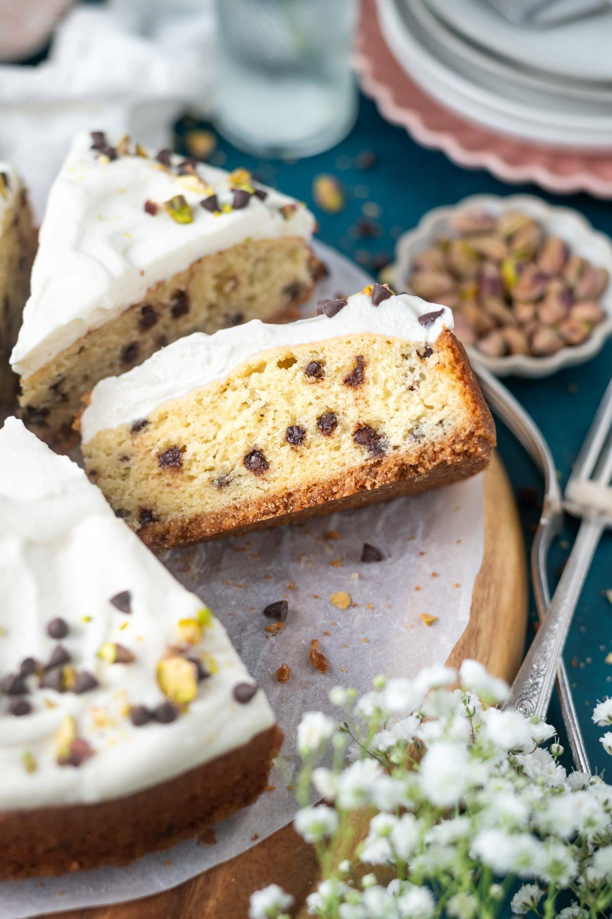 slices of cannoli cake on a cake plate with forks and plates in the background