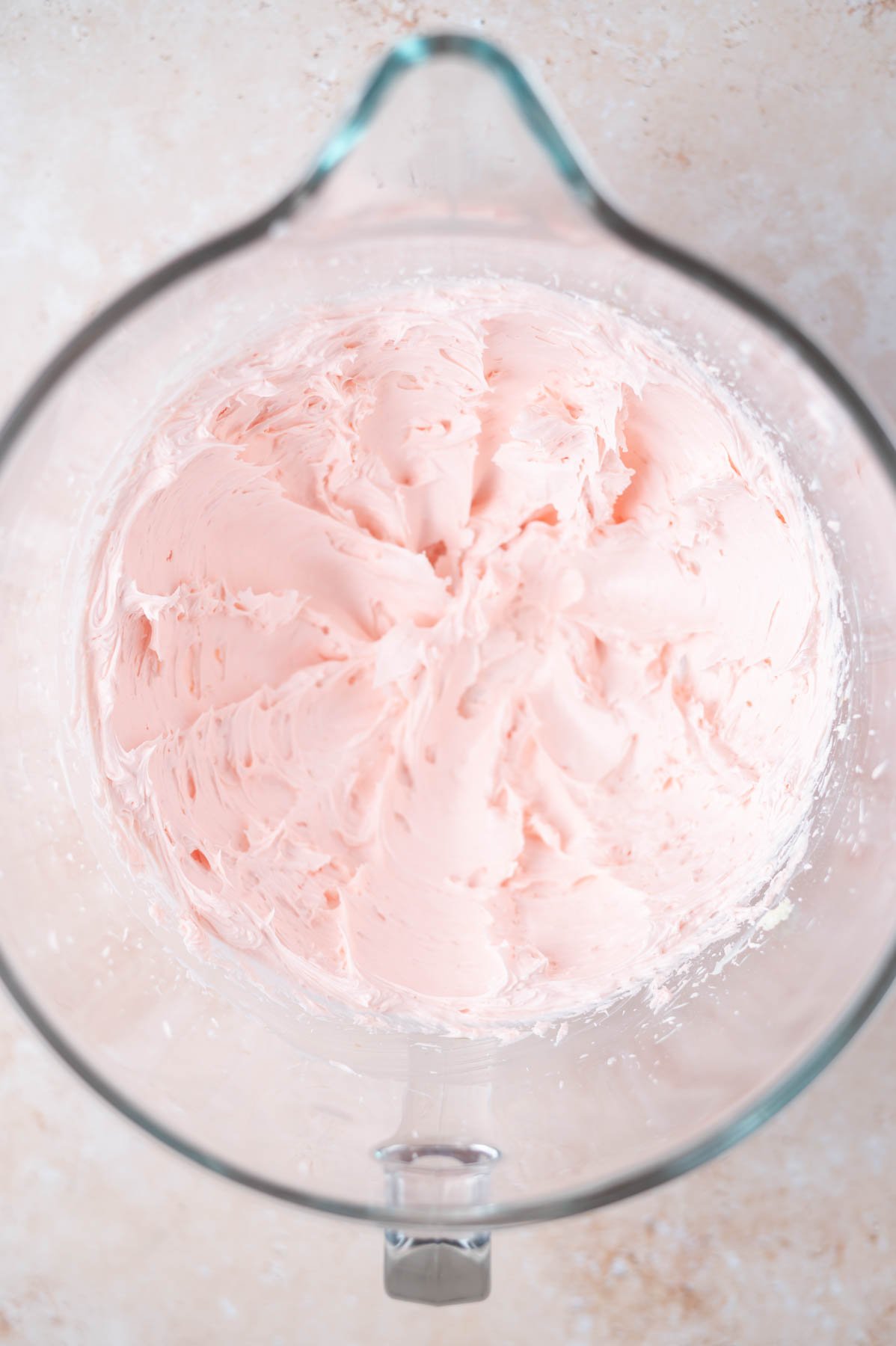 pink frosting in a mixing bowl
