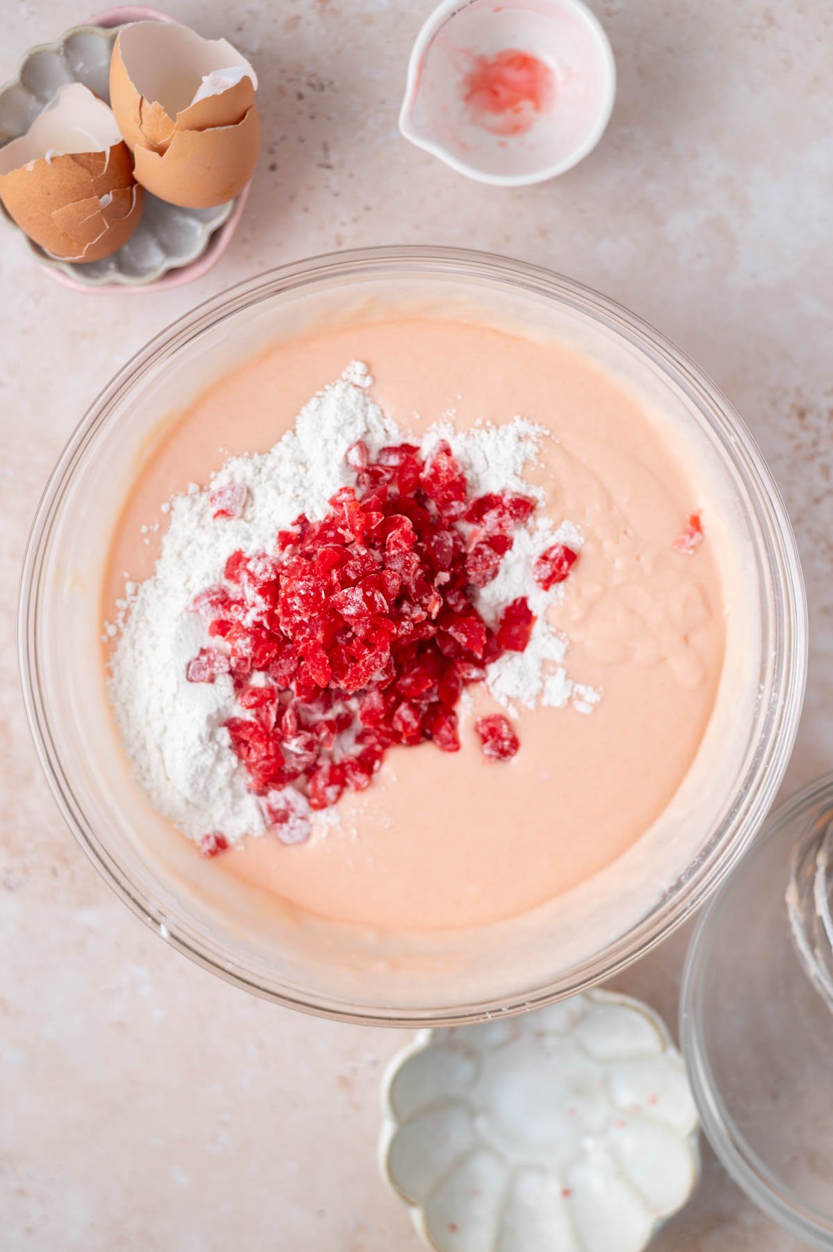 cherries tossed in flour atop cherry chip cake batter