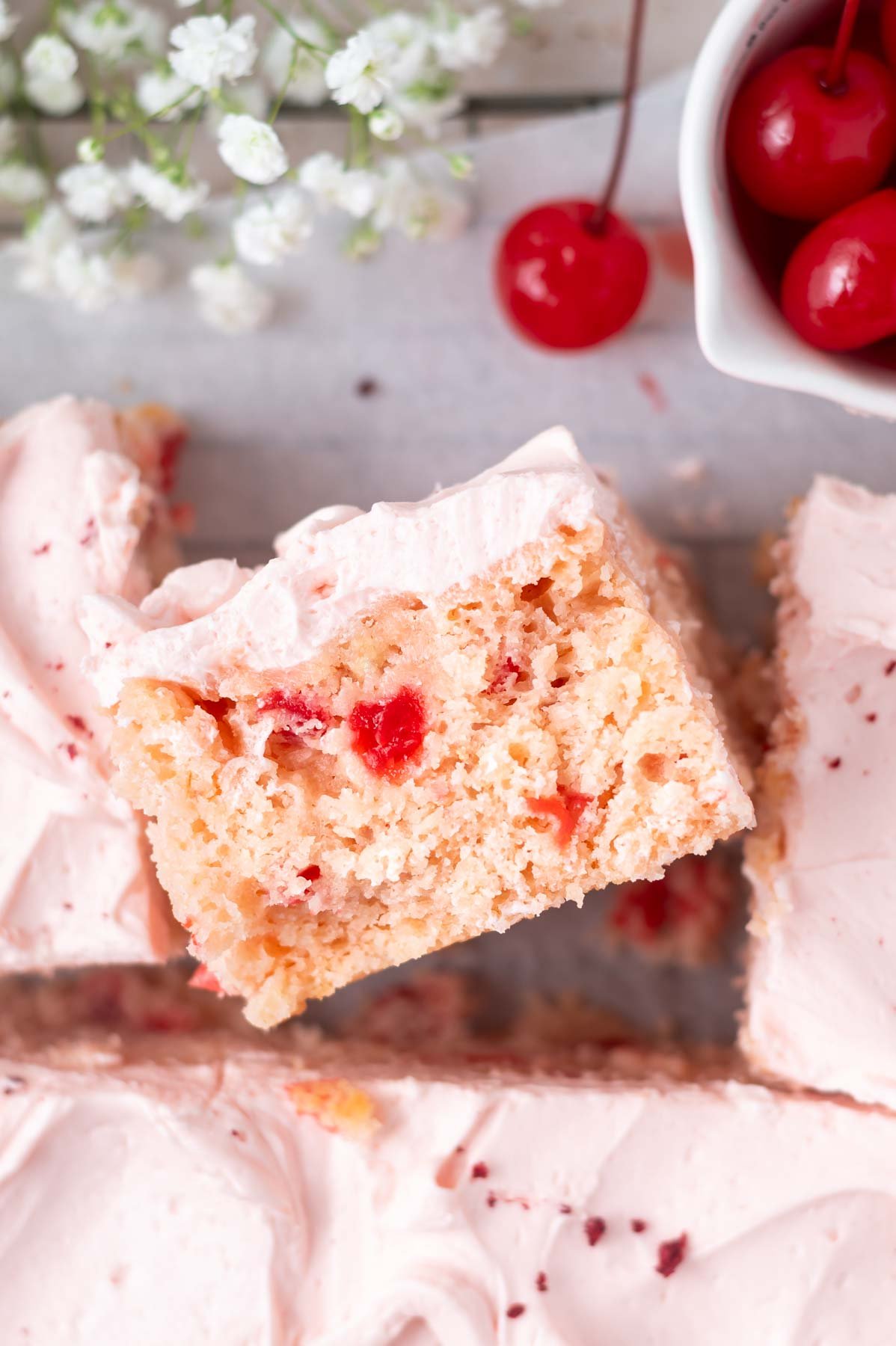 slice of cake on it's side showing cherry chips