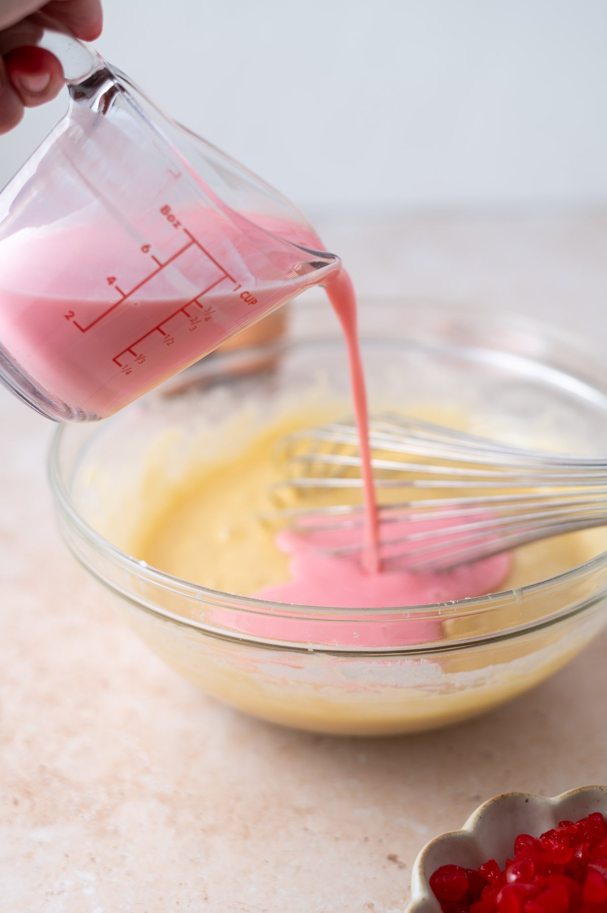 pink buttermilk being poured into batter