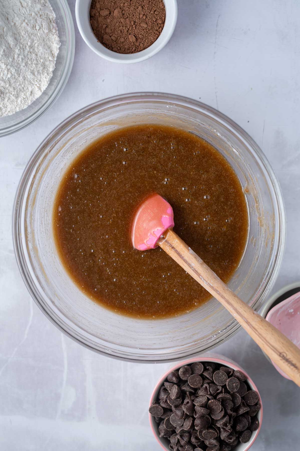 cornstarch and baking soda added to ingredients in a mixing bowl with a spatula