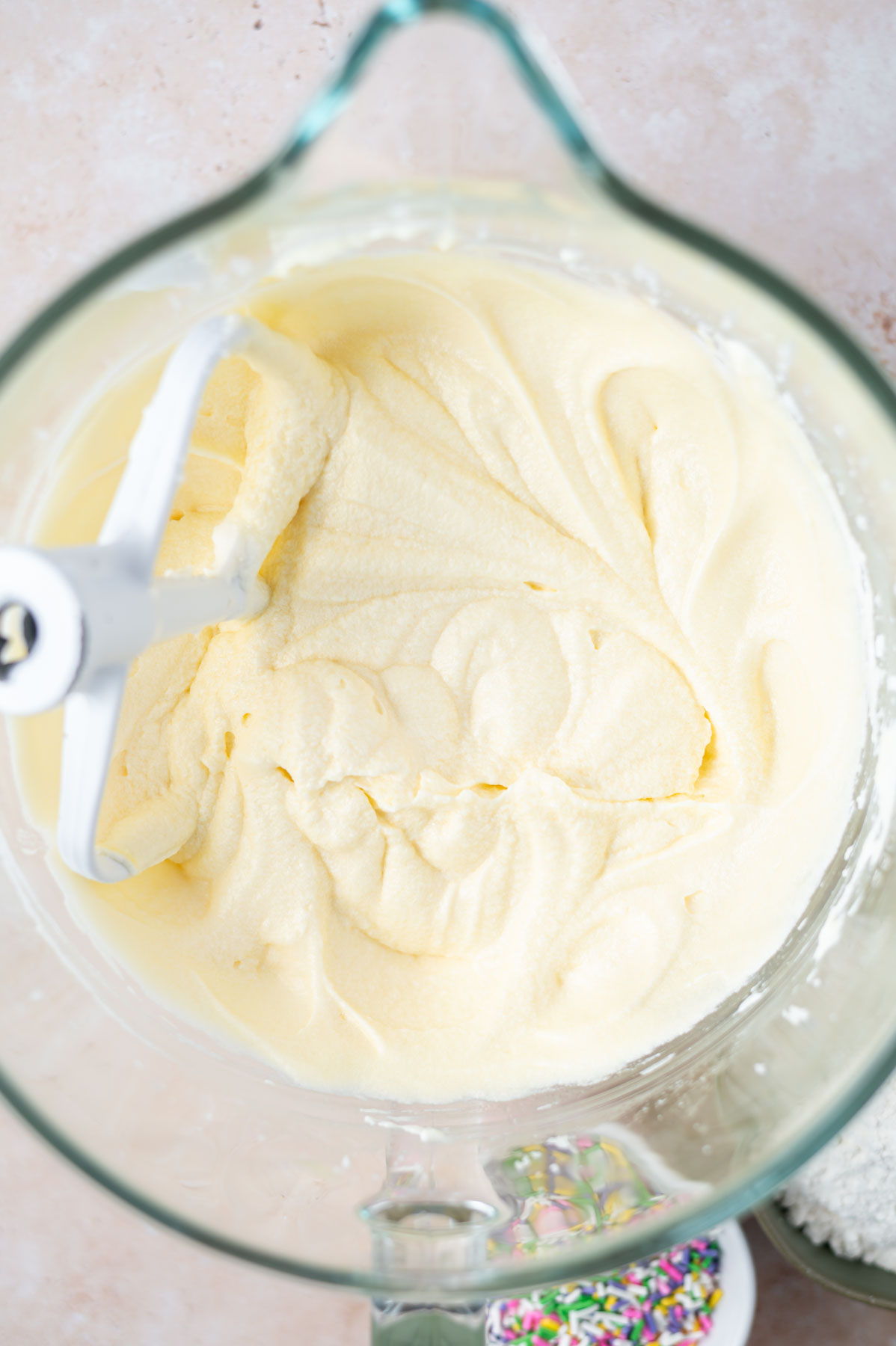cake batter in a mixing bowl after eggs have been added